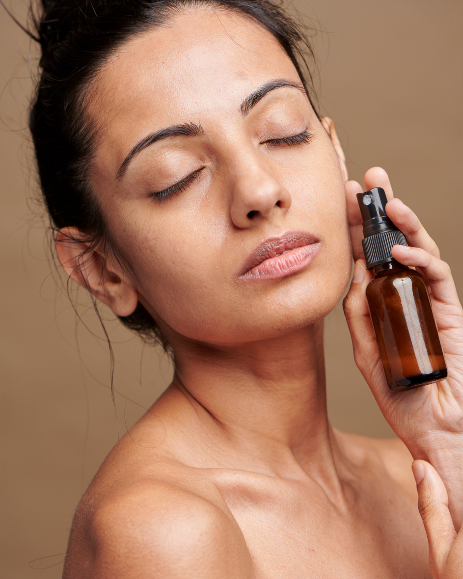 Woman Holding Bottle of Skincare Product